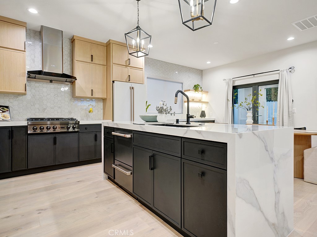 4652 Charnock Drive Irvine, CA 92604 - Photo 6 of 51 a kitchen with stainless steel appliances granite countertop a sink a stove and a refrigerator