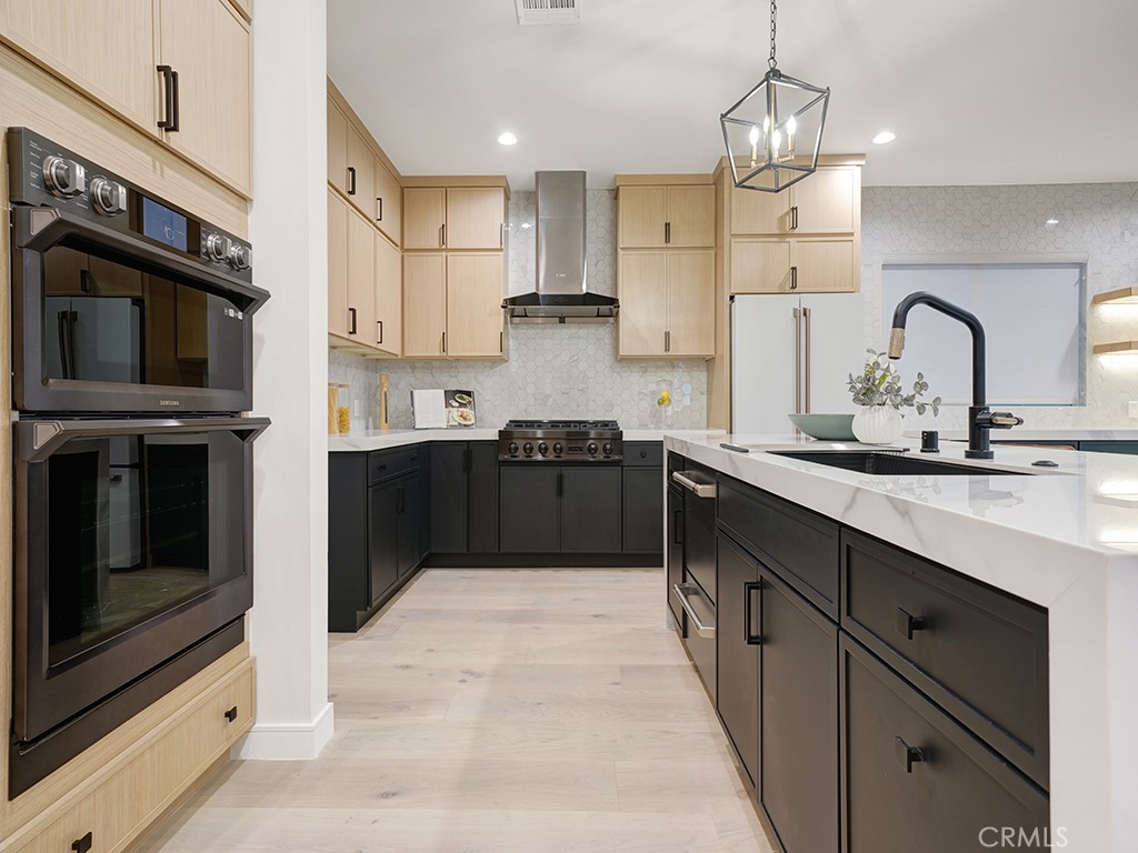 4652 Charnock Drive Irvine, CA 92604 - Photo 8 of 51 a kitchen with stainless steel appliances granite countertop a sink and cabinets