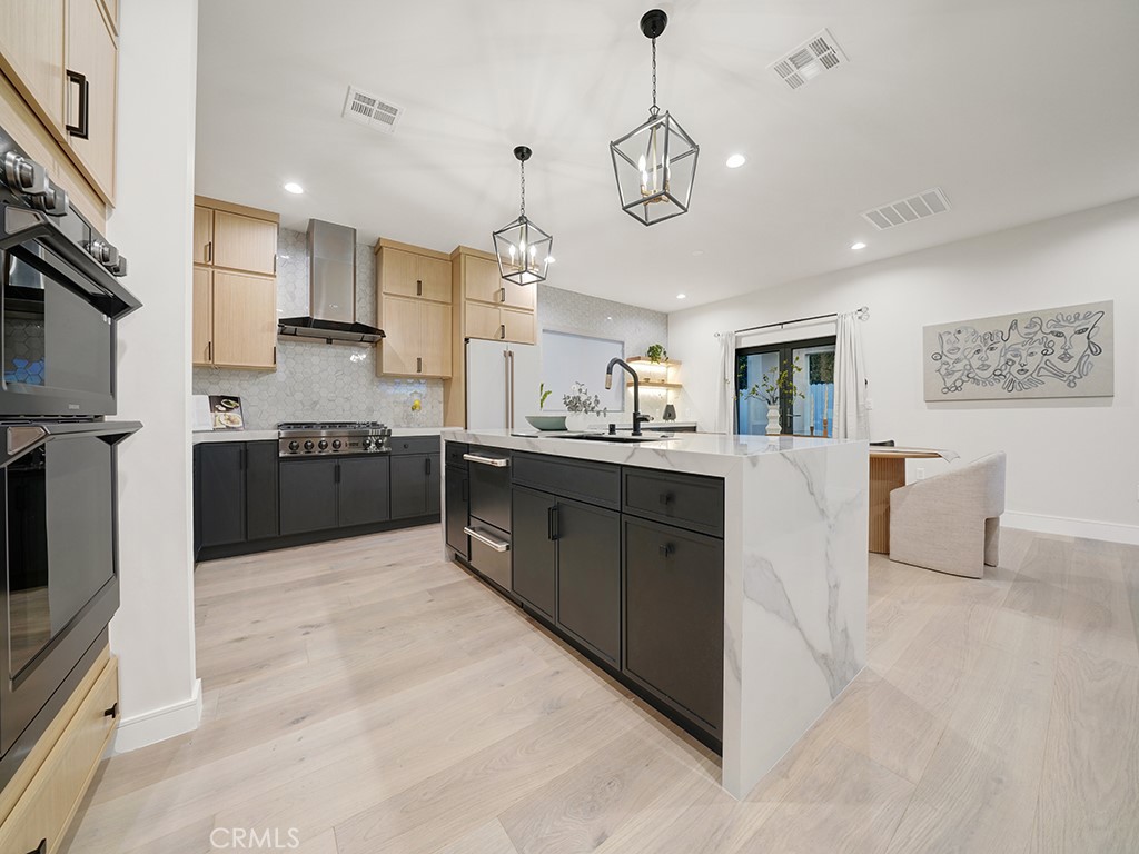 4652 Charnock Drive Irvine, CA 92604 - Photo 9 of 51 a large kitchen with stainless steel appliances granite countertop a sink and dishwasher