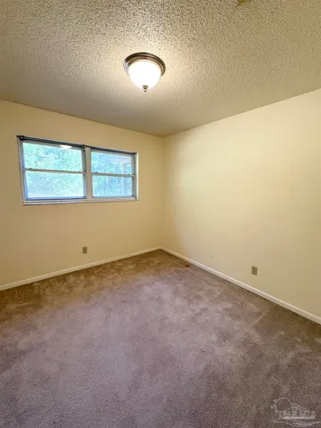 an empty room with a empty space and windows
