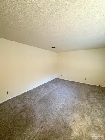 a large kitchen with window and a fireplace