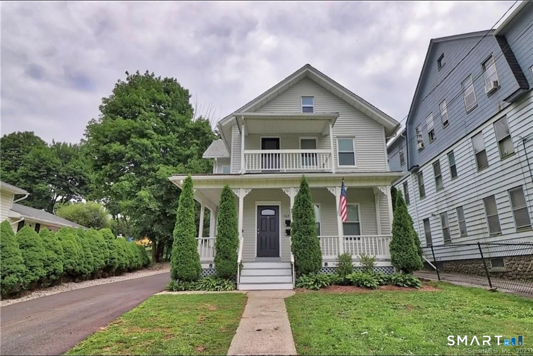 1163 West Main Street Waterbury, CT 06708 - Photo 1 of 11 a front view of a house with a yard