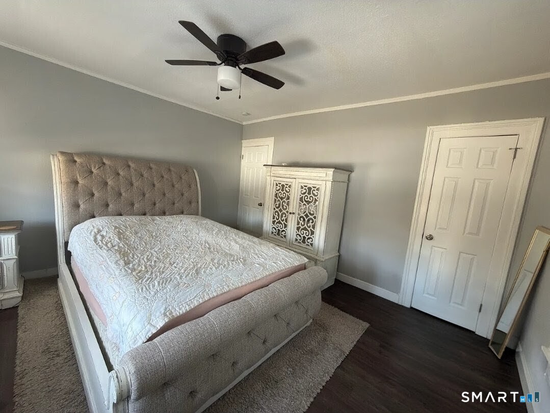 1163 West Main Street Waterbury, CT 06708 - Photo 5 of 11 a bedroom with a bed and a dresser in it