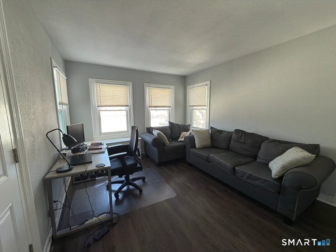 1163 West Main Street Waterbury, CT 06708 - Photo 7 of 11 a living room with furniture and a window