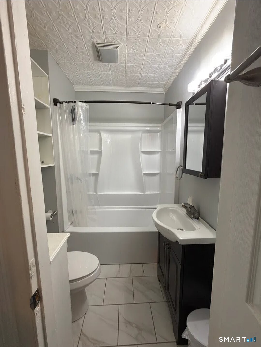 1163 West Main Street Waterbury, CT 06708 - Photo 8 of 11 a bathroom with a sink toilet vanity and shower