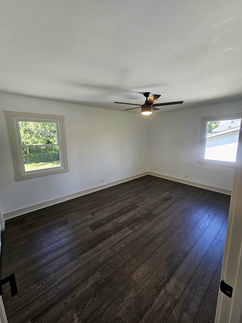 6230 Boca Rio Drive Oak Forest, IL 60452 - Photo 18 of 29 a view of an empty room with wooden floor and a window