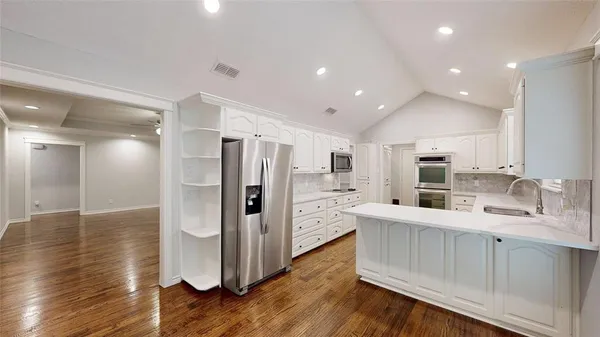 a kitchen with stainless steel appliances a refrigerator and a sink