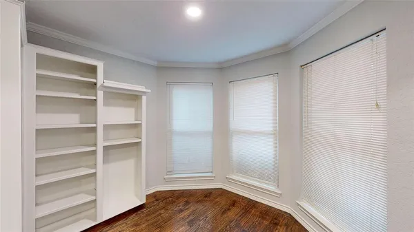 a view of room with window and wooden floor