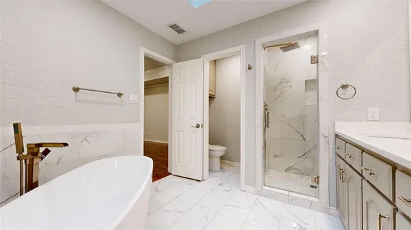 a bathroom with a granite countertop sink a mirror and a shower
