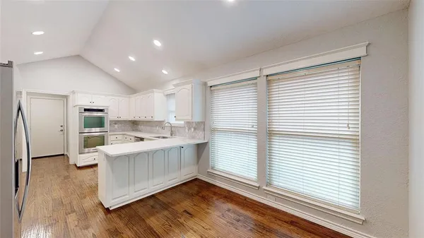a kitchen with stainless steel appliances granite countertop a sink stove and a refrigerator