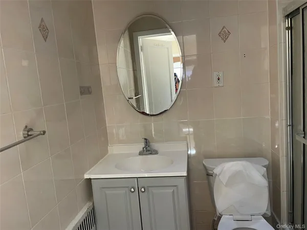 a bathroom with a toilet sink and mirror