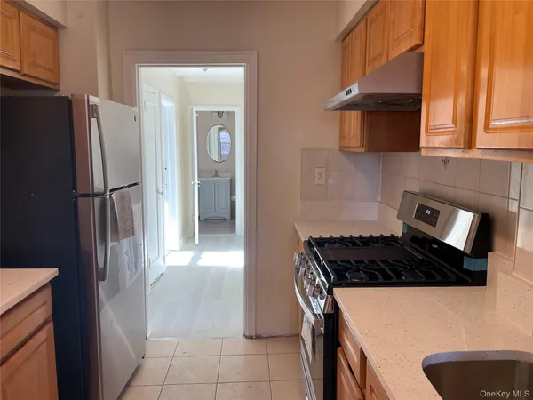 a kitchen with a refrigerator and a sink