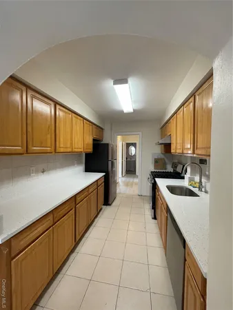 a large kitchen with a stove top oven and cabinets