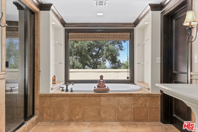 a large bathroom with a large tub and sink