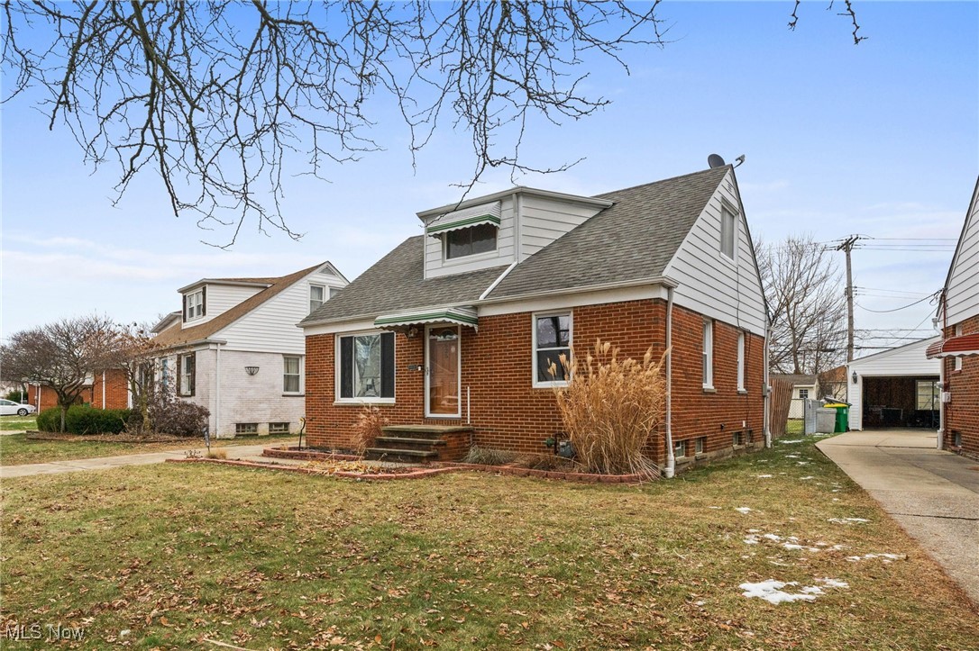 625 Pendley Road Willowick, OH 44095 - Photo 3 of 28 Bungalow-style home featuring brick siding, roof with shingles, and a front yard