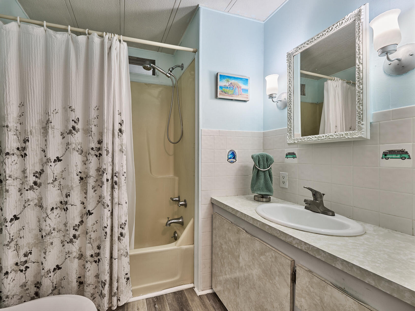 6977 Southeast Delegate Street Hobe Sound, FL 33455 - Photo 39 of 60 a bathroom with a granite countertop sink a mirror a shower and a bathtub