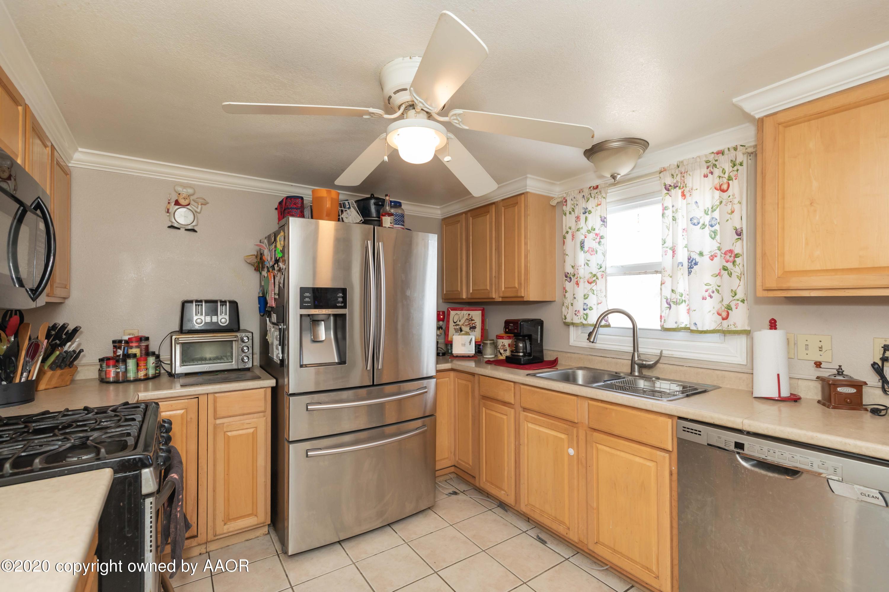 3505 South Tyler Street Amarillo, TX 79110 - Photo 11 of 29 a kitchen with stainless steel appliances a sink cabinets and a window
