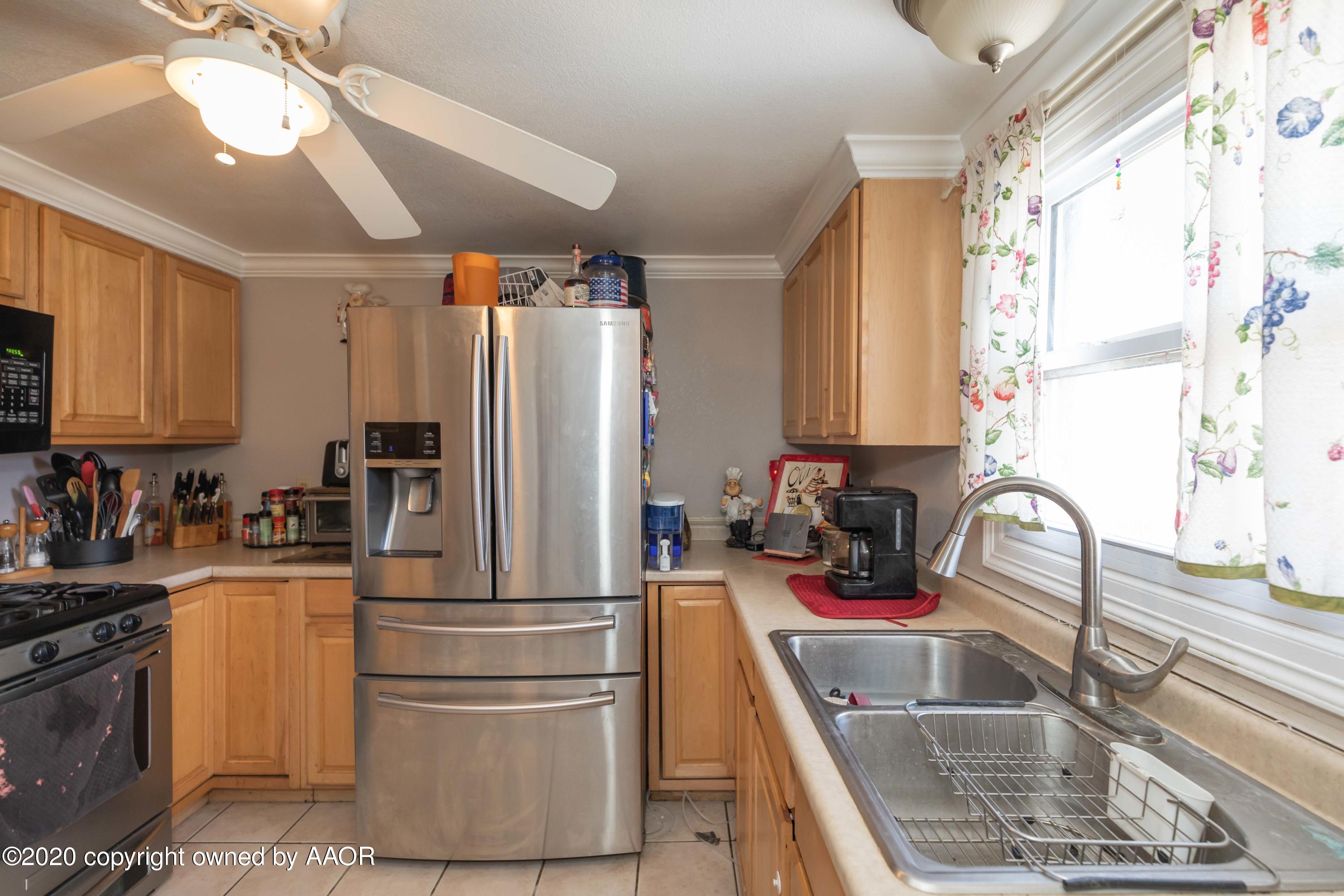 3505 South Tyler Street Amarillo, TX 79110 - Photo 12 of 29 a kitchen with refrigerator a sink and a window