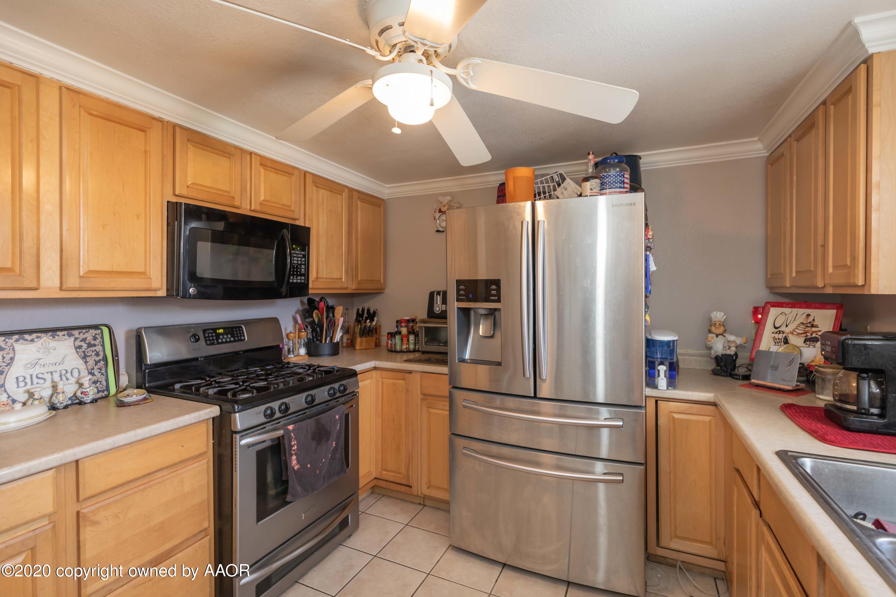 3505 South Tyler Street Amarillo, TX 79110 - Photo 13 of 29 a kitchen with stainless steel appliances a refrigerator stove and microwave