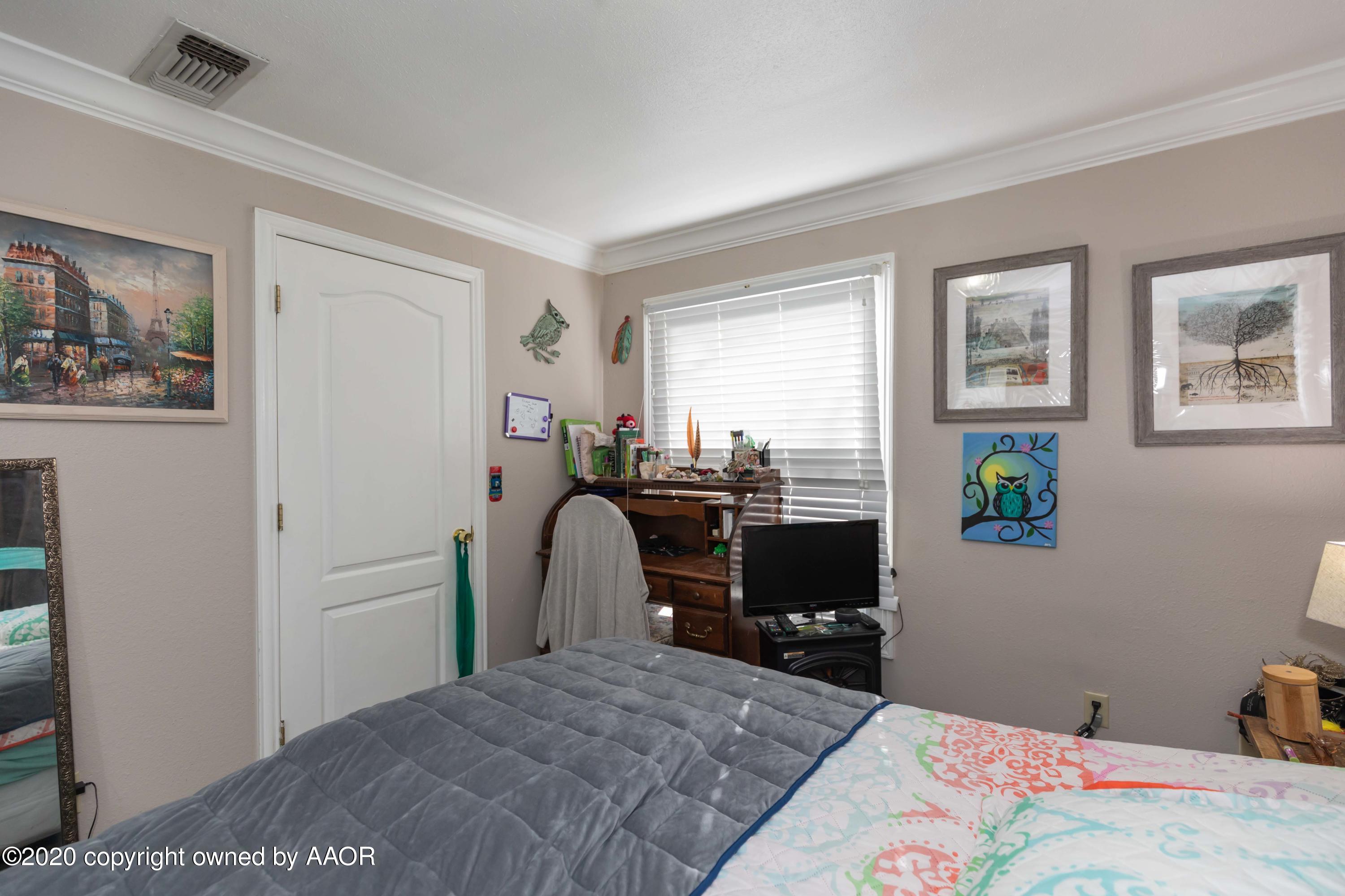 3505 South Tyler Street Amarillo, TX 79110 - Photo 16 of 29 a bedroom with a bed and wooden floor
