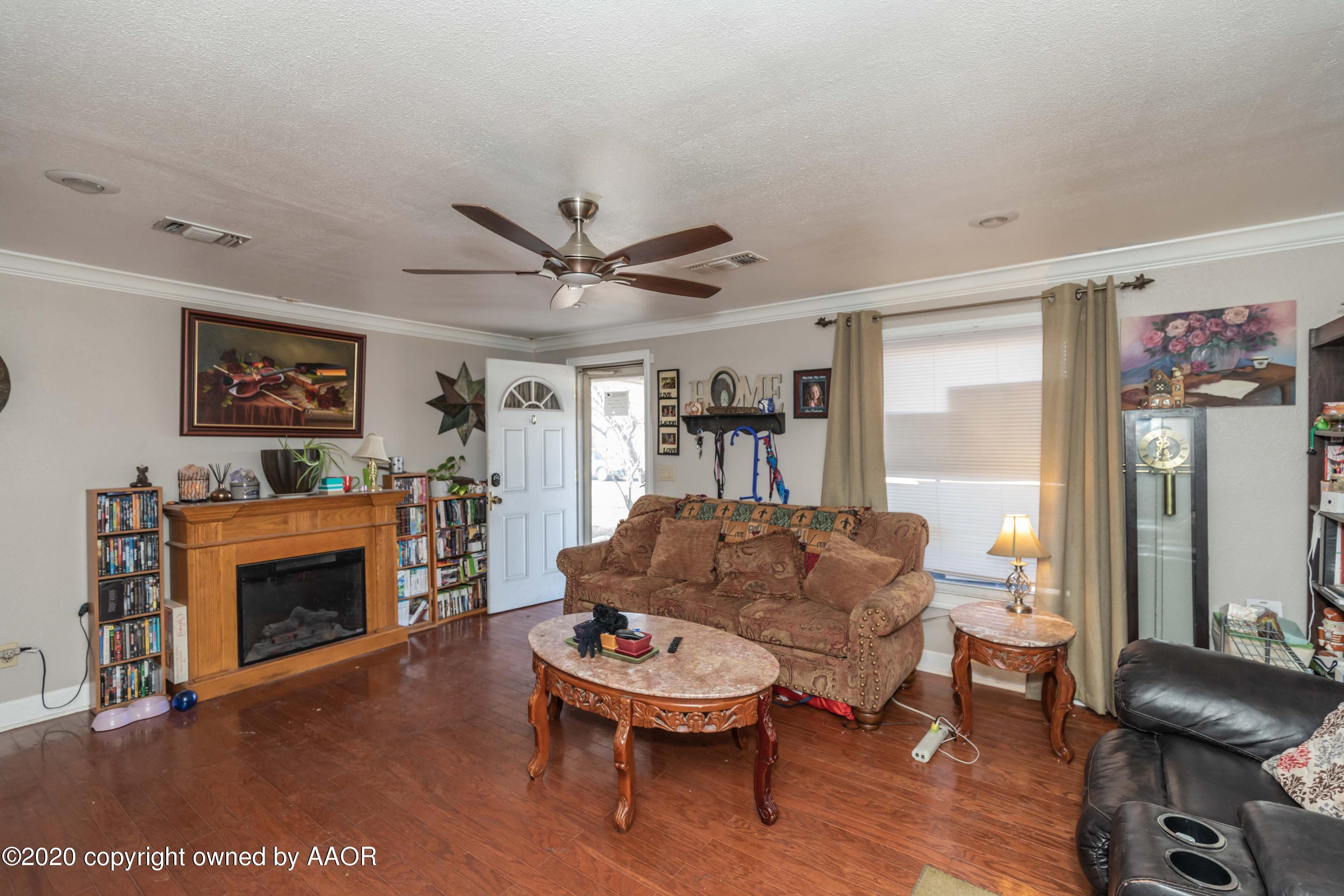 3505 South Tyler Street Amarillo, TX 79110 - Photo 8 of 29 a living room with furniture a window and a fireplace