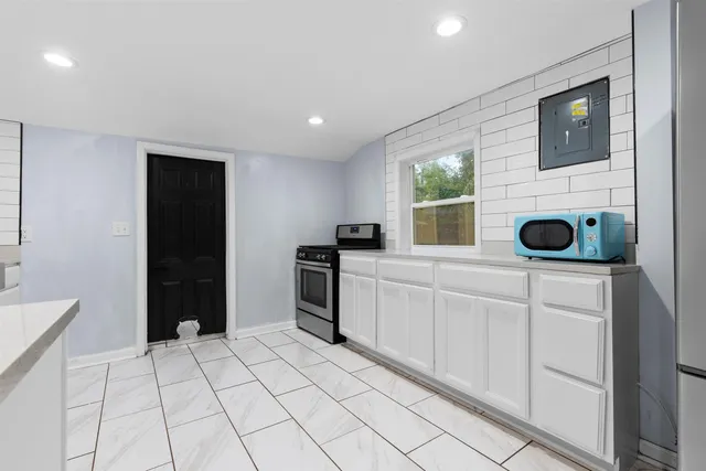 a kitchen with a stove a sink and a refrigerator