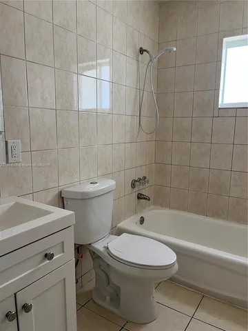a bathroom with a toilet a sink and bathtub