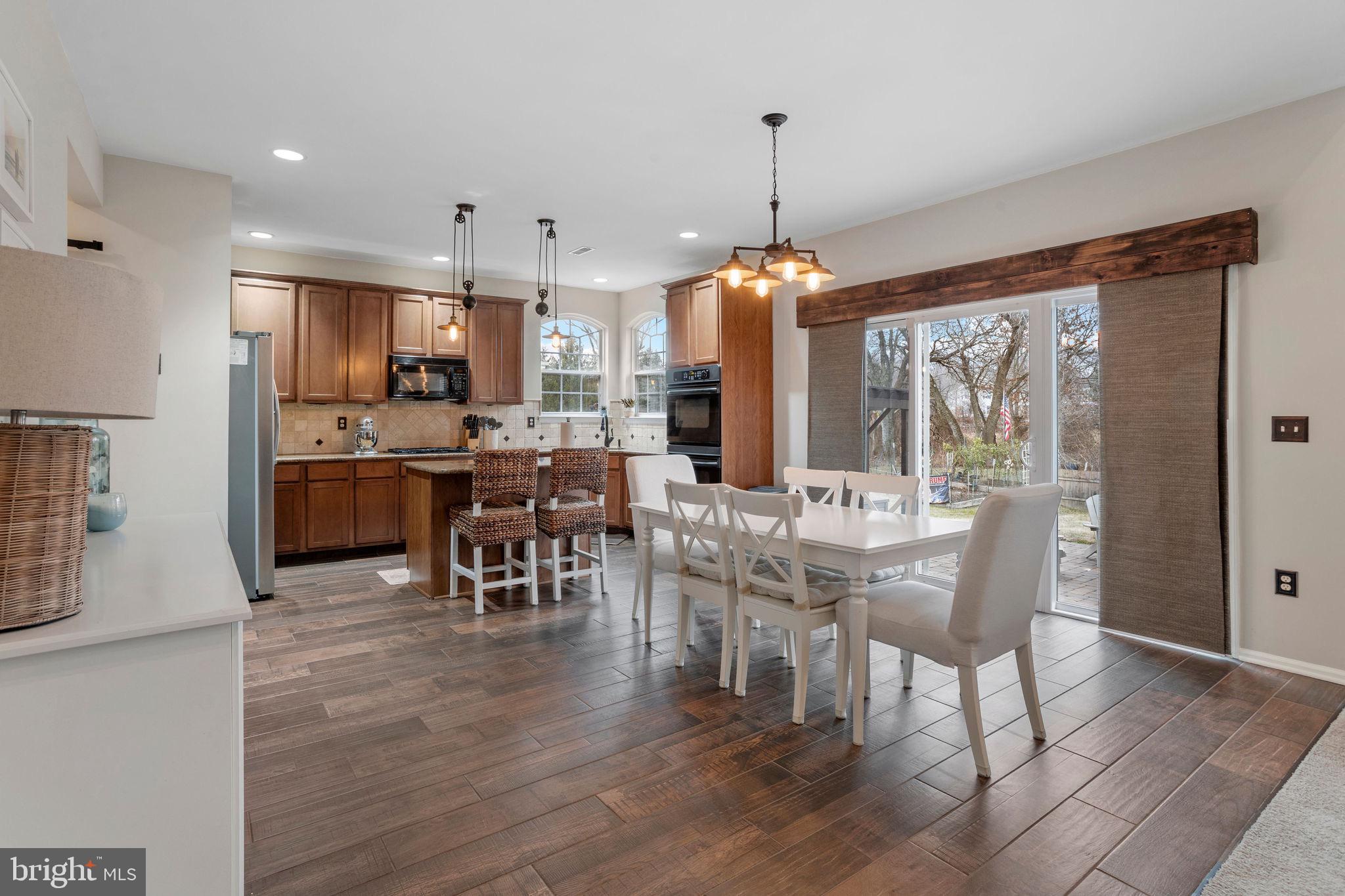 233 Windsor Drive Swedesboro, NJ 08085 - Photo 12 of 46 a view of a dining room and livingroom with furniture wooden floor a chandelier