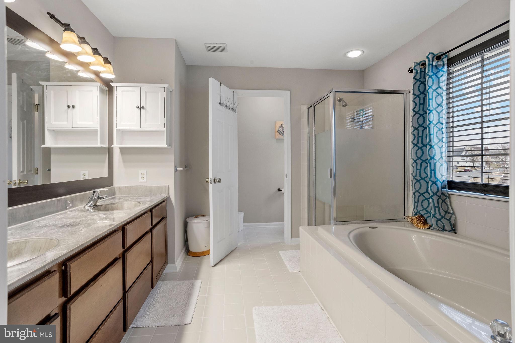 233 Windsor Drive Swedesboro, NJ 08085 - Photo 26 of 46 a spacious bathroom with a granite countertop tub sink and mirror