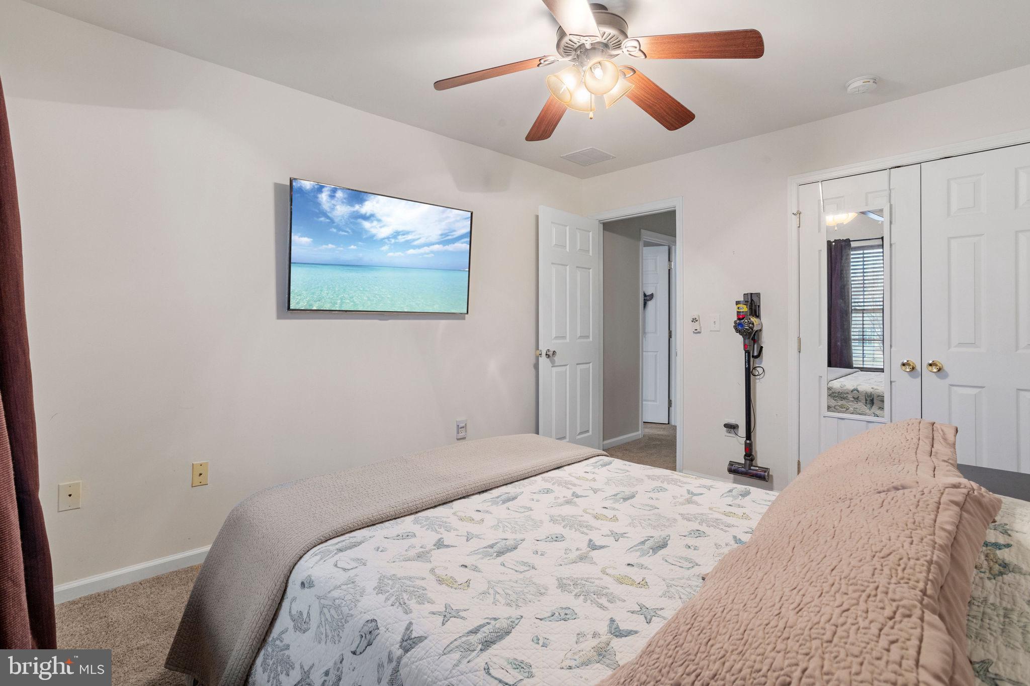 233 Windsor Drive Swedesboro, NJ 08085 - Photo 32 of 46 a bedroom with a large bed and a chandelier