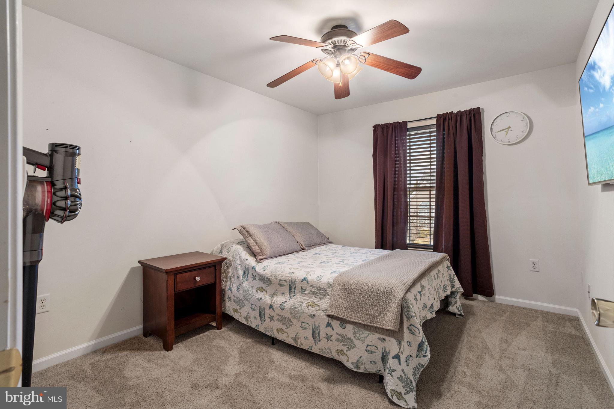 233 Windsor Drive Swedesboro, NJ 08085 - Photo 33 of 46 a bedroom with a bed and a chandelier