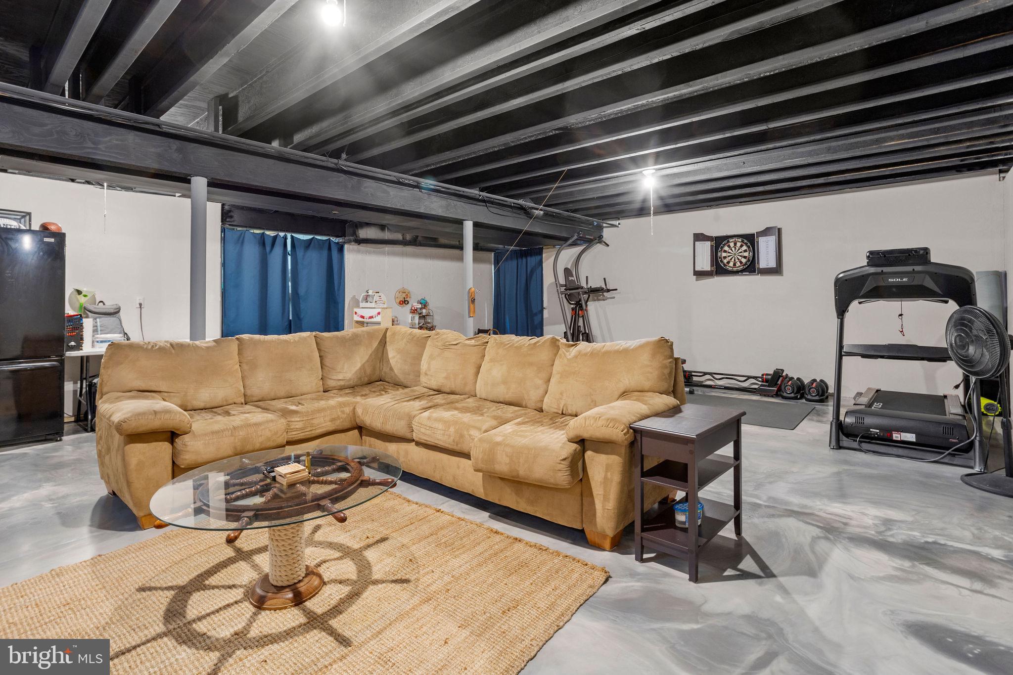 233 Windsor Drive Swedesboro, NJ 08085 - Photo 35 of 46 a living room with furniture and a flat screen tv