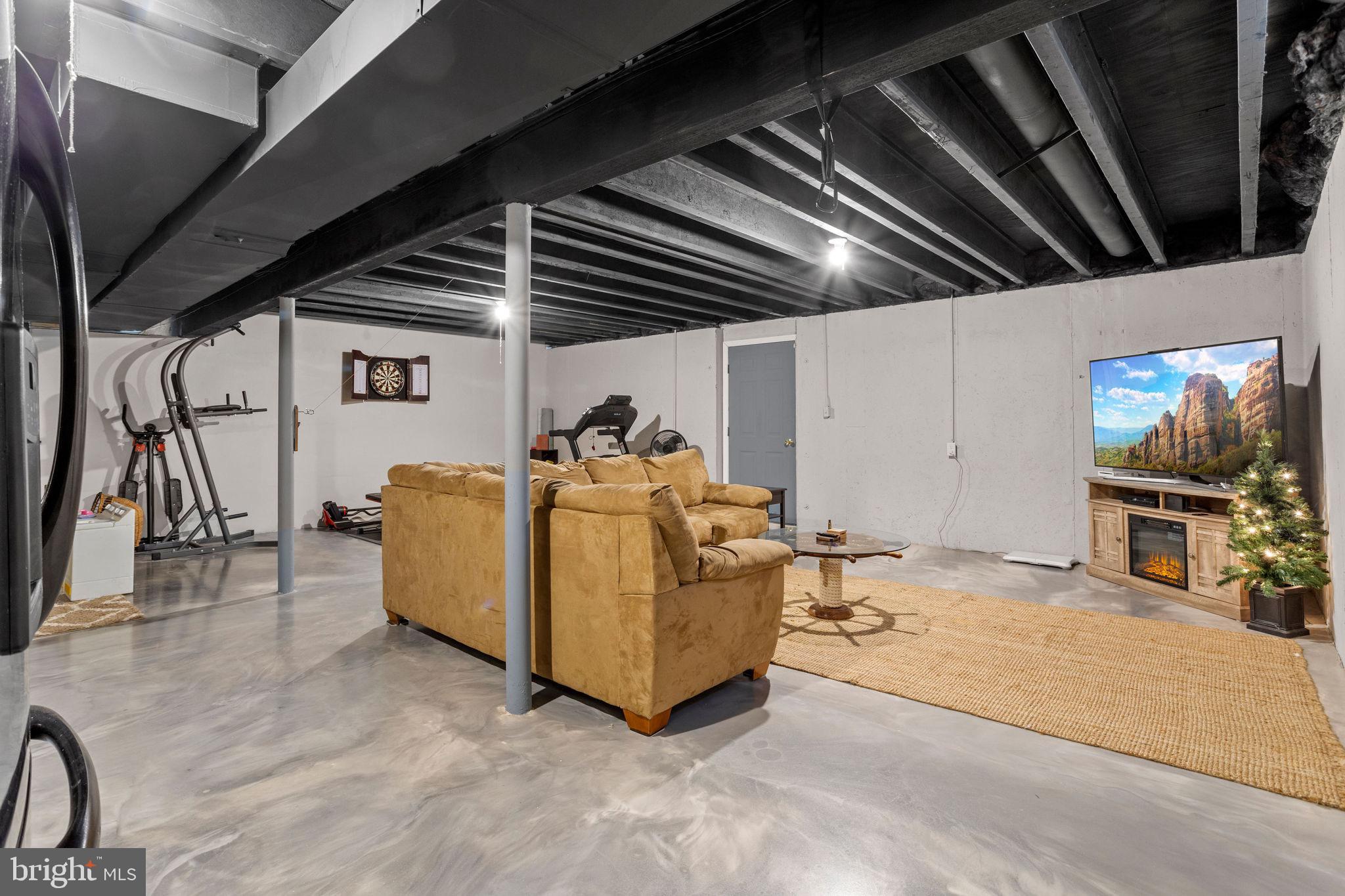 233 Windsor Drive Swedesboro, NJ 08085 - Photo 37 of 46 a living room with furniture and a flat screen tv