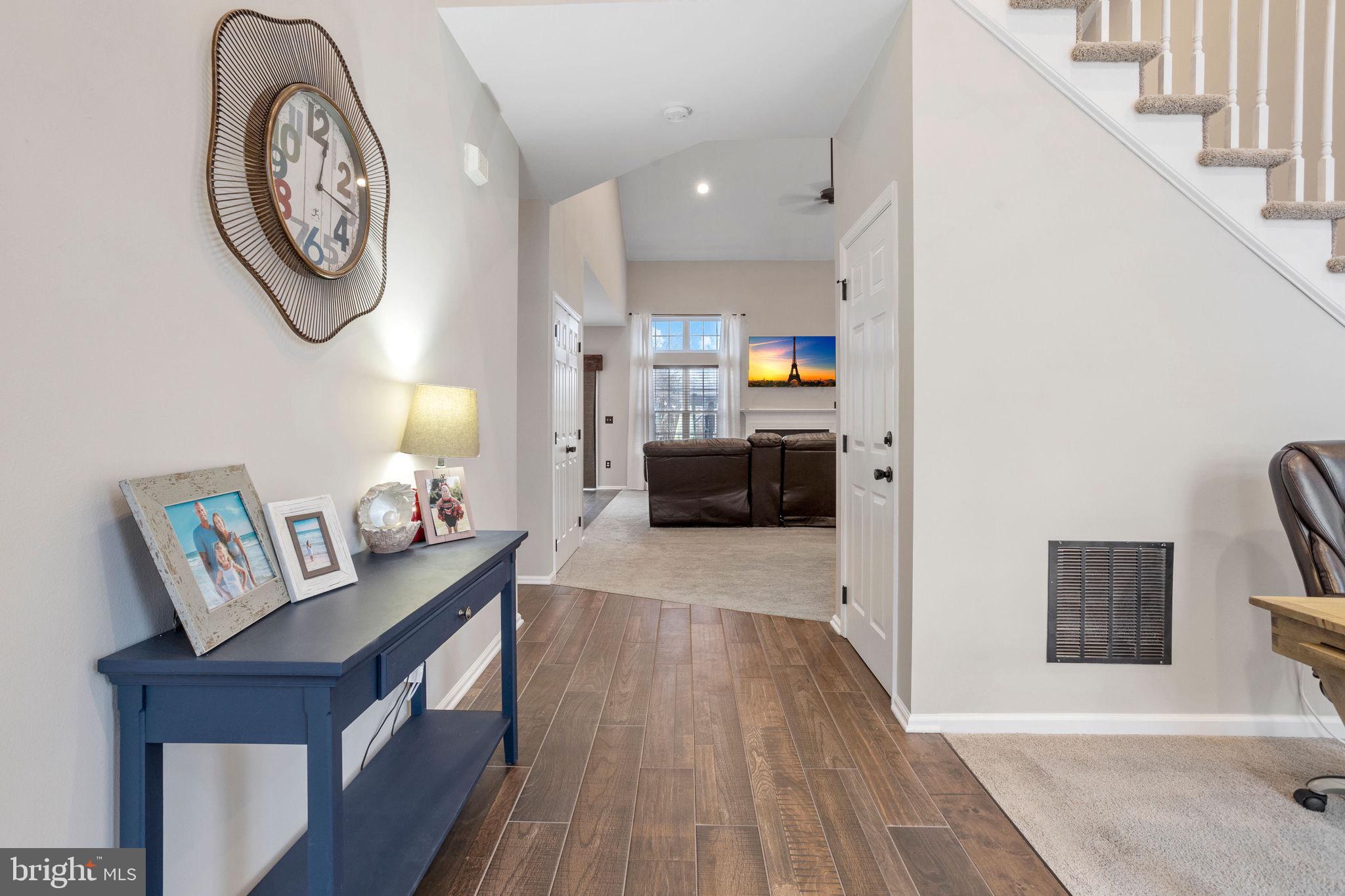 233 Windsor Drive Swedesboro, NJ 08085 - Photo 4 of 46 a living room with furniture a clock on wall and a table