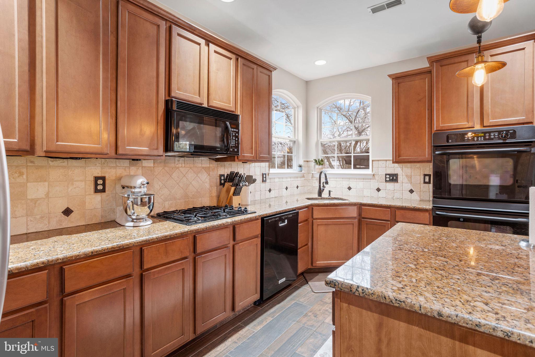 233 Windsor Drive Swedesboro, NJ 08085 - Photo 9 of 46 a kitchen with stainless steel appliances kitchen island granite countertop a sink stove and cabinets