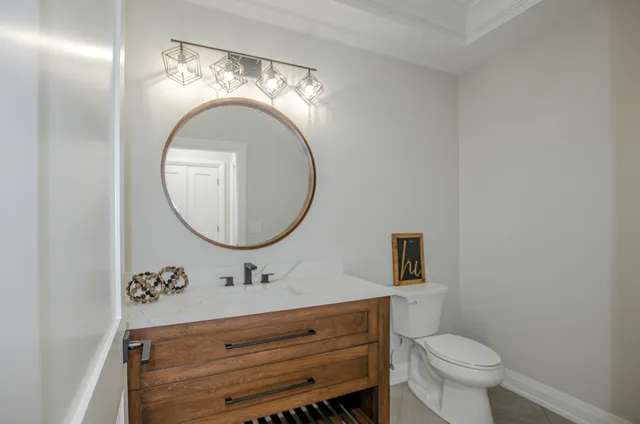 a bathroom with a toilet a sink and mirror