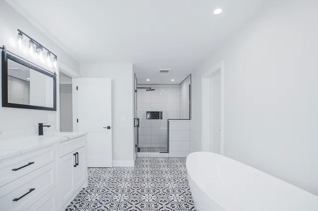 a bathroom with a sink a toilet and shower