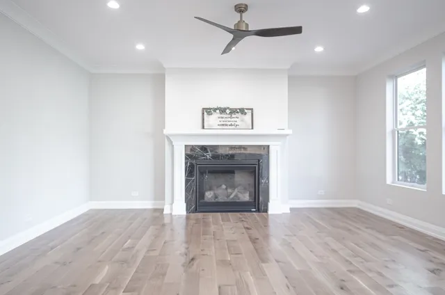 an empty room with windows and a fireplace