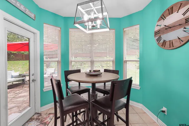 a view of a dining room with furniture and a window