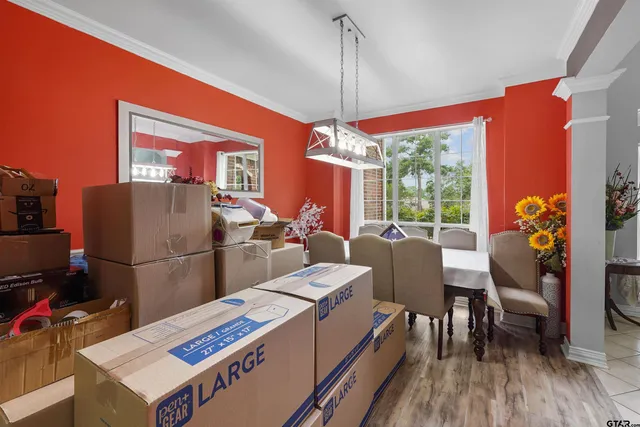 a dining room with furniture and chandelier