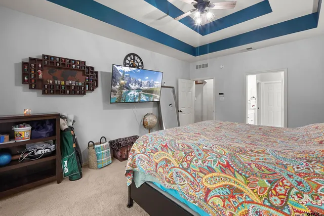 a bedroom with a bed and a chandelier