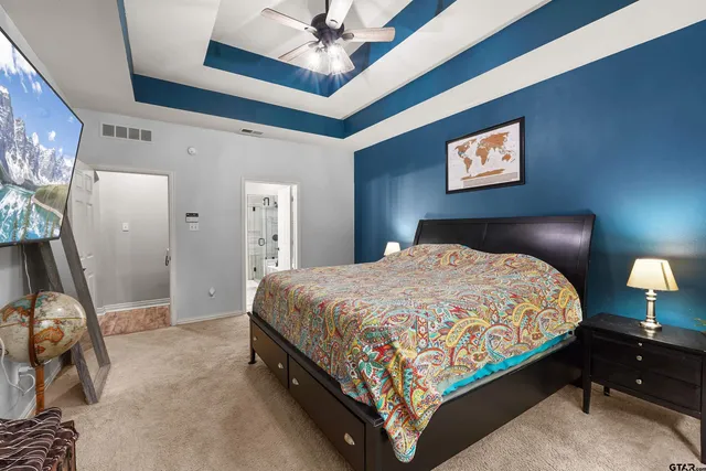 a bedroom with a bed and a lamp