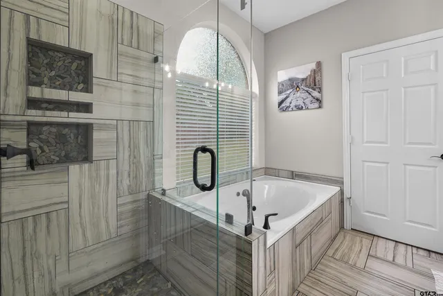 a bathroom with a bathtub and shower