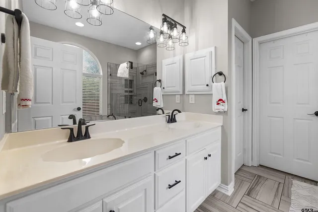 a bathroom with a sink double vanity and a mirror