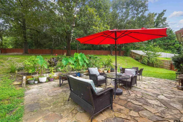 a view of a backyard with sitting area and furniture