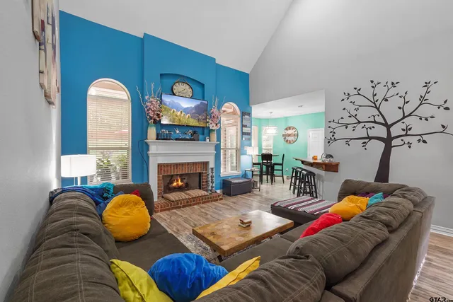 a living room with furniture fireplace and a fireplace
