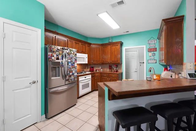 a kitchen with refrigerator cabinets and furniture