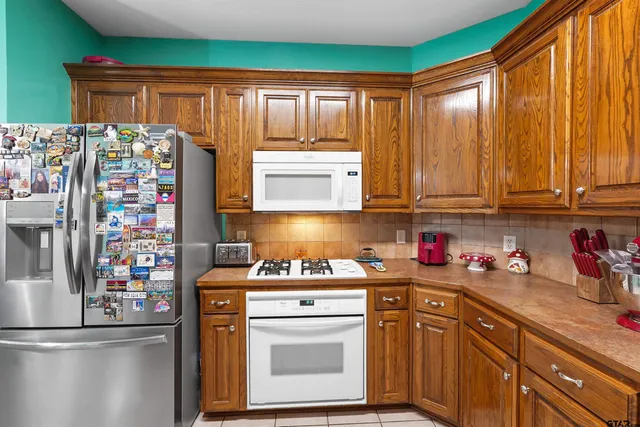 a kitchen with stainless steel appliances a refrigerator sink and cabinets