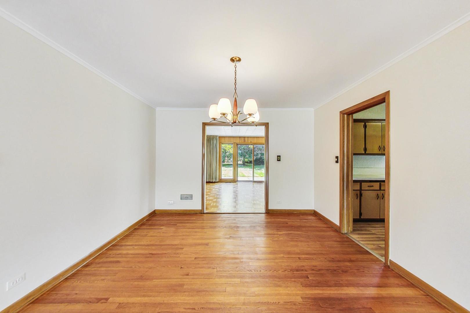1906 Manor Lane Park Ridge, IL 60068 - Photo 8 of 40 a view of an empty room with window and wooden floor