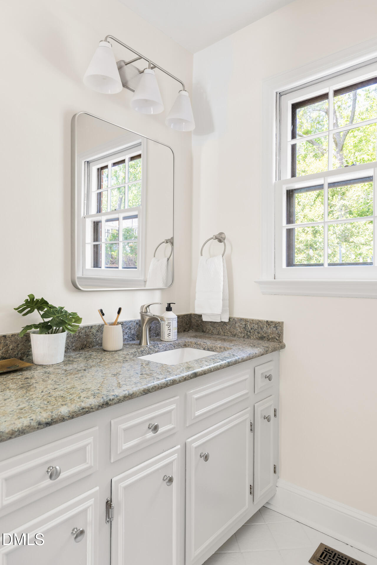 1706 Wallace Street Durham, NC 27707 - Photo 31 of 55 a kitchen with granite countertop white cabinets and window